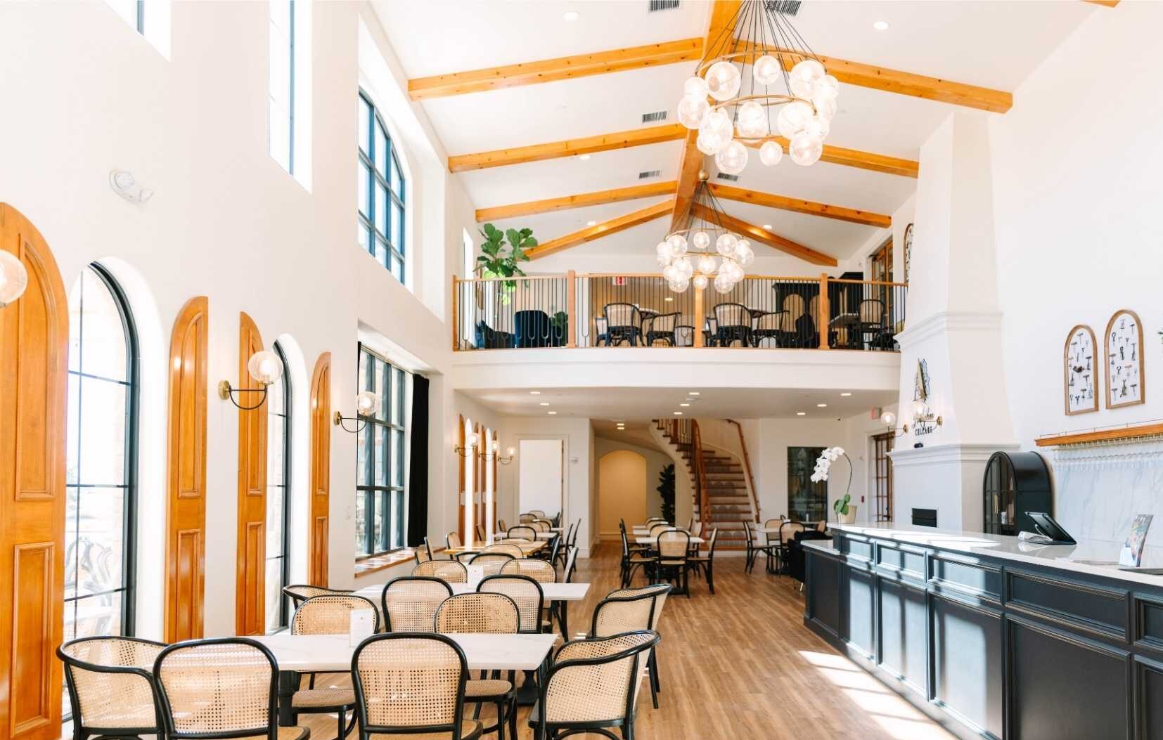 Interior image of the Adelphos Cellars tasting room with seating, fireplace, and a balcony