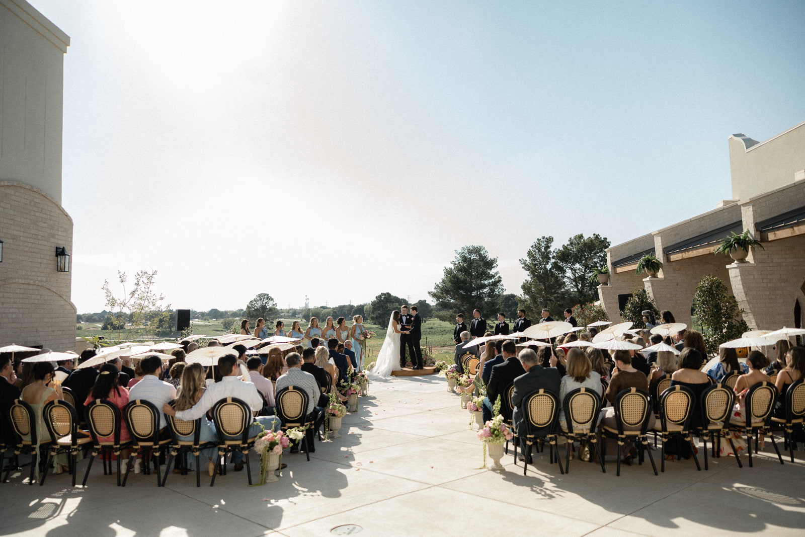A bride and groom during an elegant, Mediterranean-inspired courtyard wedding at Adelphos Cellars in Lubbock, Texas.